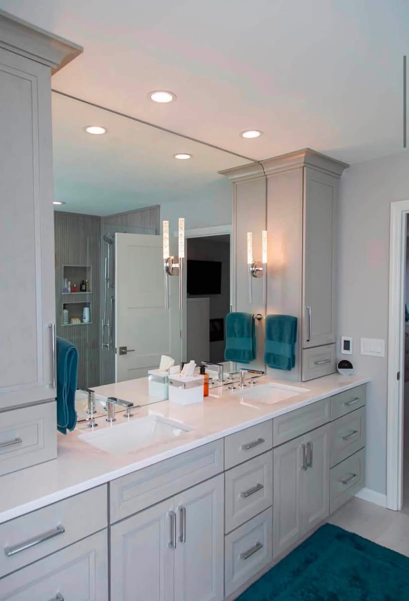 After: bright double vanity with painted cabinets, quartz counters and modern fixtures